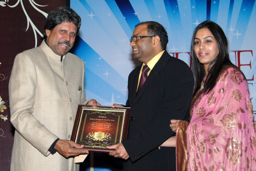 Habitat Design and Arts receiving the Times Research Best Interior Design Company award from cricket legend Kapil Dev